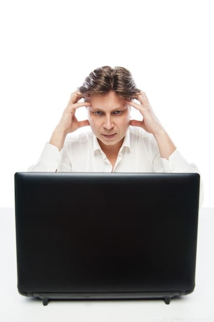 A person looking at a blank computer screen with a confused expression