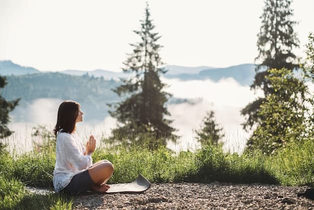 A person meditating or taking a deep breath outdoors