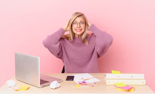 A person sitting at a desk looking overwhelmed by multiple open browser tabs