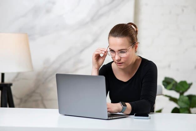Someone focusing intently on a laptop screen